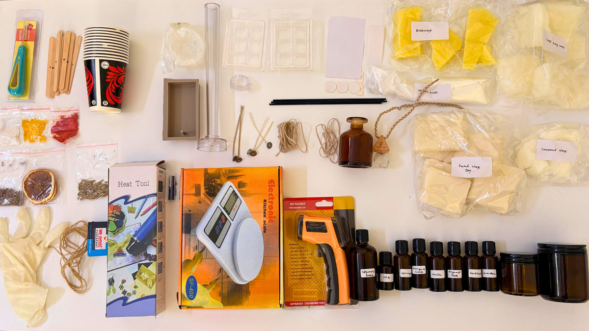 The full Mikaya masterclass kit laid out and labelled: four waxes, six fragrance oils, moulds, jars, wicks, embeds, colour and tools