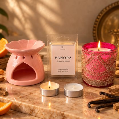 Chandni & Vanora Set: pink ceramic Dahlia wax melter, Vanora orange and vanilla wax melts, a pink Chandni jar candle with zari work and two tealights